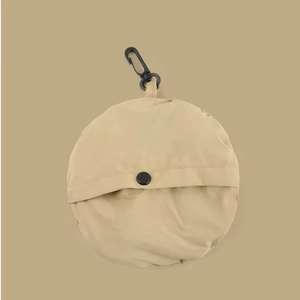 Close-up of beige foldable storage bag pouch with black clip hook and snap button