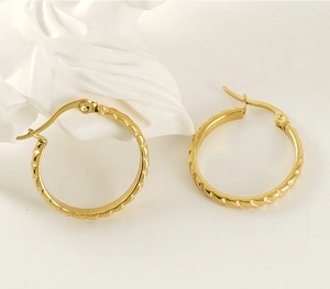 Detailed shot of 18K gold plated twisted hoop earrings with a secure clasp design