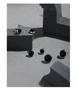 Detailed view of minimalist S925 silver stud earrings with round black onyx stones