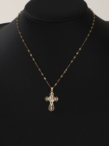 Detailed close-up of a golden cross necklace with colorful micro-inlaid zircons on a bust