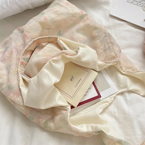 Detailed view of the embroidered butterfly tote bag interior with large capacity