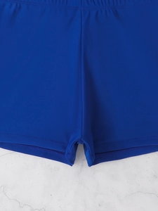 Detail of navy blue swim shorts with elastic waistband and durable stitching