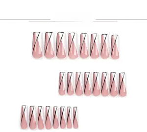 Detail view of long coffin press-on nails with pink base and black geometric diagonal lines