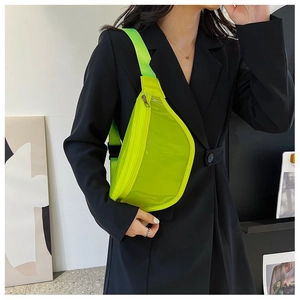 Detail of neon green transparent PVC chest bag with black buckle on model in black suit
