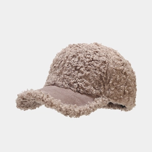 Close-up of winter teddy fleece baseball cap with soft lamb wool and suede brim detail