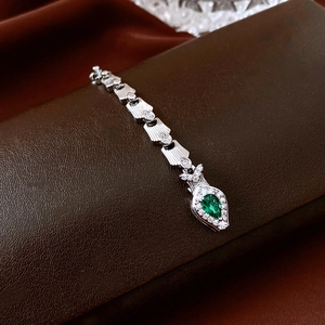 Exquisite silver snake-style chain with emerald drop pendant and pavé set crystals