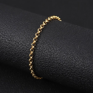 Macro view of 18K gold-plated stainless steel rolo chain bracelet on black leather stand