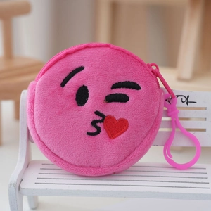 Detailed close-up of pink plush round coin purse with embroidered winking emoji