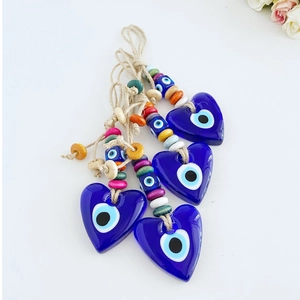 Three heart-shaped Turkish evil eye glass charms with colorful beads and natural hemp rope