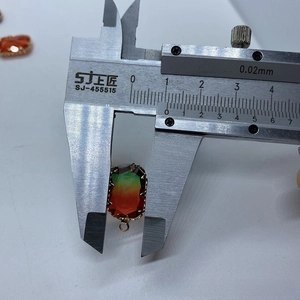 Macro shot of a 15mm faceted gradient stone pendant measured with a digital caliper
