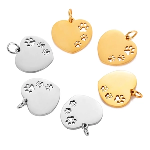 Polished stainless steel heart pendants with hollow paw prints in gold and silver