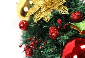 Detail of Christmas wreath with red glitter balls, berries, and golden sequin flowers
