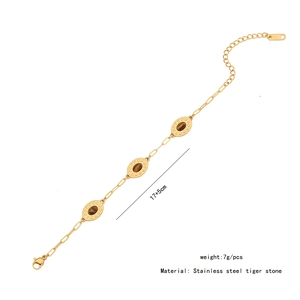 Detail of vintage gold stainless steel bracelet featuring three oval tiger eye stones