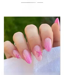 Close-up of pink gradient almond nails with glitter and 3D starfish charms
