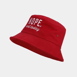 Detail of red cotton bucket hat featuring white embroidered NOPE. not today text