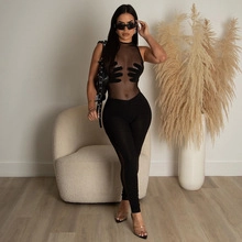 Detail of slim fit black mesh bodysuit with unique hand-shaped patchwork design