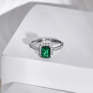 Macro shot of S925 sterling silver ring with green rhombic zircon and pavé diamonds