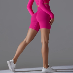 Detail view of pink seamless yoga shorts featuring high waist and scrunch butt lifting effect
