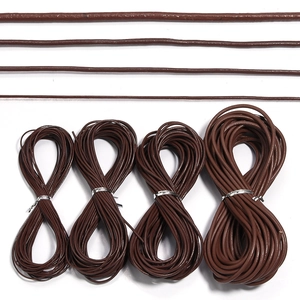 Detail showing four different diameters of dark brown leather cords for jewelry making