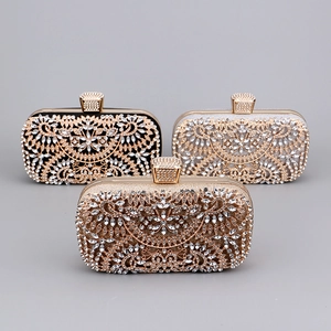 Detailed view of three luxury evening clutch bags with sparkling rhinestones and metal filigree