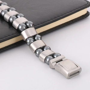 Macro shot of men's double-row hematite and stainless steel bracelet on leather