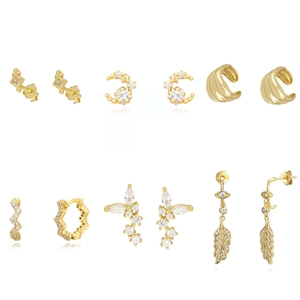 Golden earrings set with cubic zirconia stones featuring moon stars and leaf designs