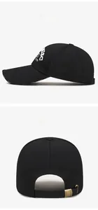 Close-up of black baseball cap featuring white 1986 embroidery and metal back buckle