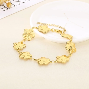Close-up of golden stainless steel flower bracelet with lobster clasp and extension chain