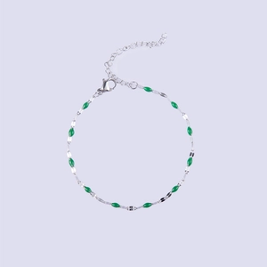 Detail of silver stainless steel chain bracelet with green enamel olive beads and clasp