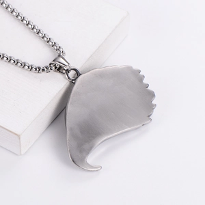 Polished silver owl-head punk necklace pendant in stainless steel on white pedestal