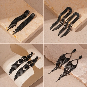 Dark gothic geometric tassel earrings with black rhinestones in a luxury four-grid display
