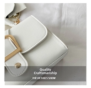 Detailed macro view showing white litchi texture PU leather with gold buckle and strap