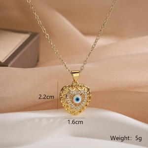 Macro detail of gold plated heart evil eye necklace with dimensions 2.2cm and 5g weight