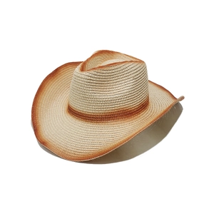 Detail of gradient brown woven texture on a straw cowboy beach hat with wide brim