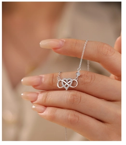Macro shot of 925 sterling silver infinity heart pendant with sparkling zircons