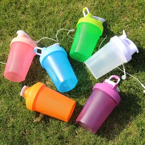 Colorful sports protein shaker bottles with carry loops on a natural lawn background