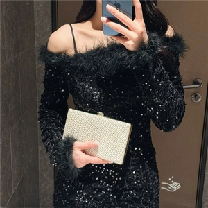 Elegant gold woven texture hard shell clutch bag paired with a black sequin evening gown