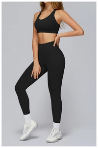 Detail of cross-back hollow sports bra and high-waisted yoga leggings set in black