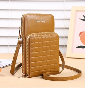 Close-up of caramel multi-layer crossbody phone bag with embossed grid pattern