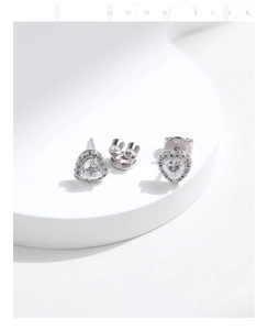 Macro shot of S925 sterling silver heart-shaped moissanite studs with clear hallmark