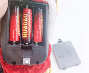 Detail of the battery compartment for electric climbing Santa showing 3 AA slots