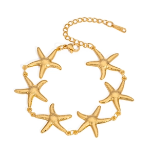 Macro shot of gold starfish bracelet featuring hammered textures and adjustable chain link