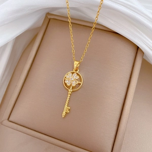 Luxury rotating gold key pendant necklace with sparkling diamonds on satin background