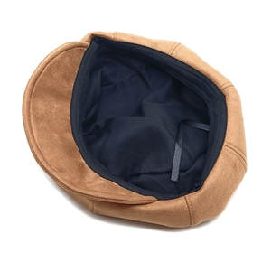 Detail view of the soft brown suede newsboy cap featuring fabric lining and adjustment drawstring