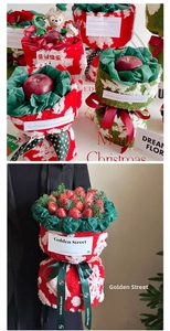 Detail of Christmas apple bouquet with plush fabric wrapping and festive decorations