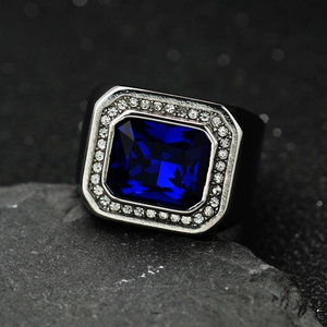 Men's square blue gemstone ring with silver diamond halo and black wide band on stone