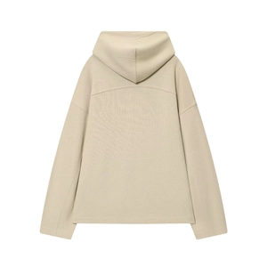 Close-up of beige knitted hoodie back showing soft cotton texture and drop shoulder design