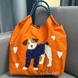 Vibrant orange nylon tote bag with cute dog towel embroidery and blue rope handles