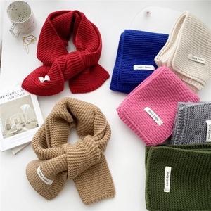 Thick knitted winter scarves in multiple colors with textured weave and brand tags
