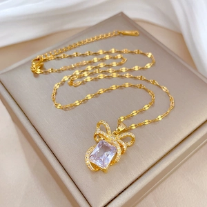 Luxurious gold titanium necklace with a crystal bow pendant and square gemstone